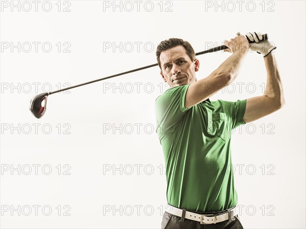 Caucasian man playing golf