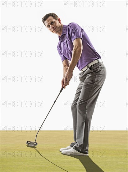 Caucasian man playing golf