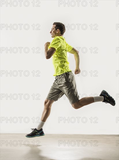 Caucasian man jogging indoors