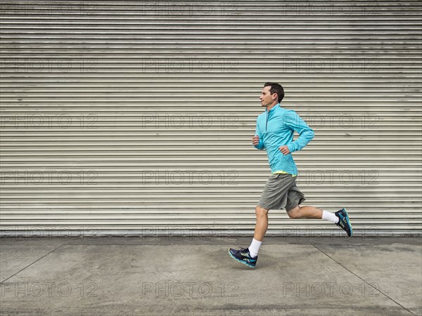 Caucasian man running on city street