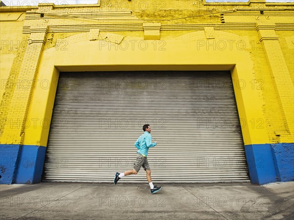 Caucasian man running on city street