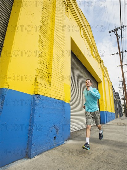 Caucasian man running on city street