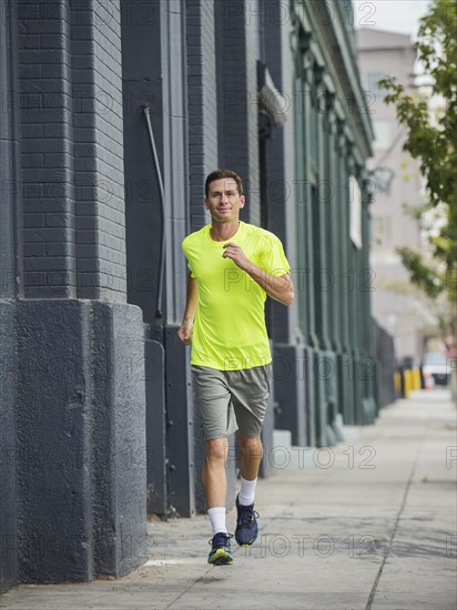 Caucasian man running on city street