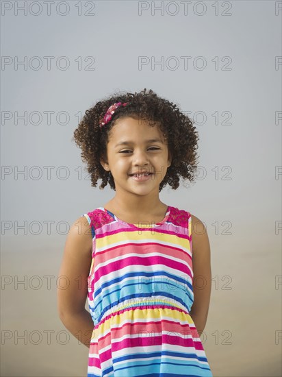 Black girl smiling on beach