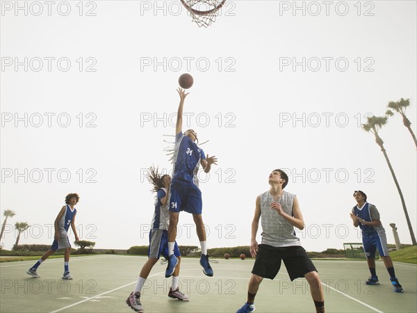 Basketball teams playing on court