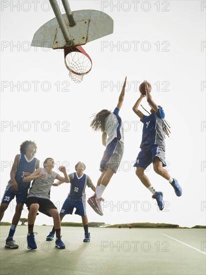 Basketball teams playing on court