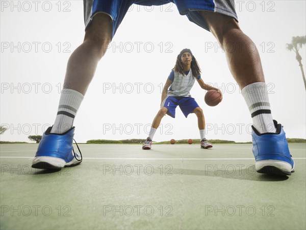 Basketball teams playing on court