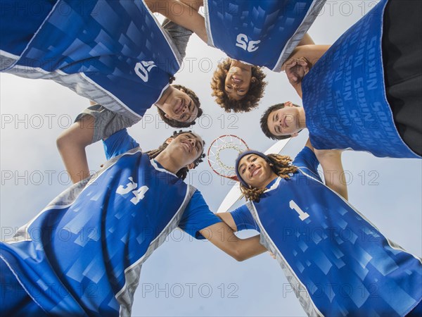 Basketball team smiling on court