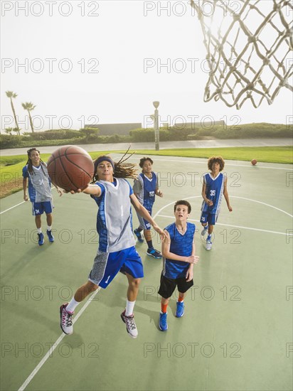 Basketball teams playing on court