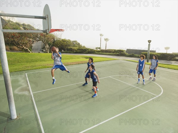 Basketball teams playing on court