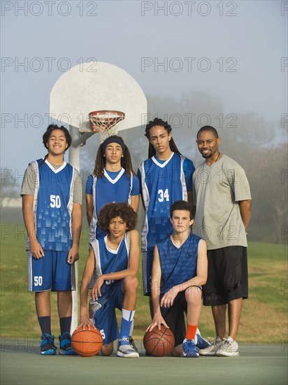 Basketball team posing on court