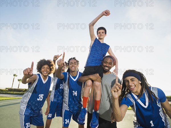 Basketball team cheering on court