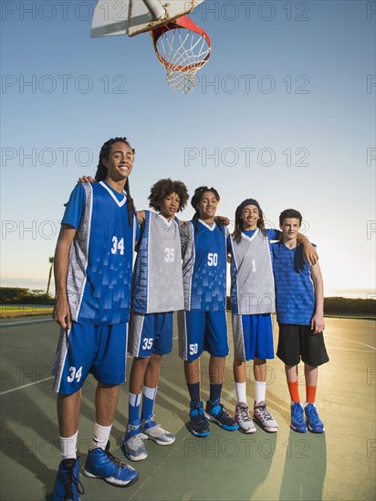 Basketball team posing on court