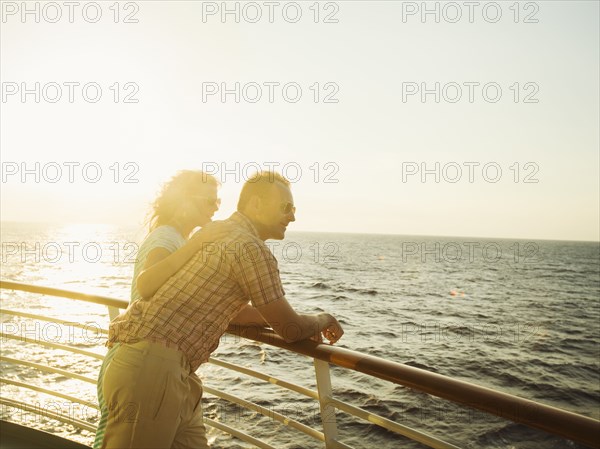 Caucasian couple admiring view from boat deck