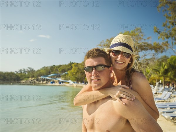 Caucasian couple hugging on beach