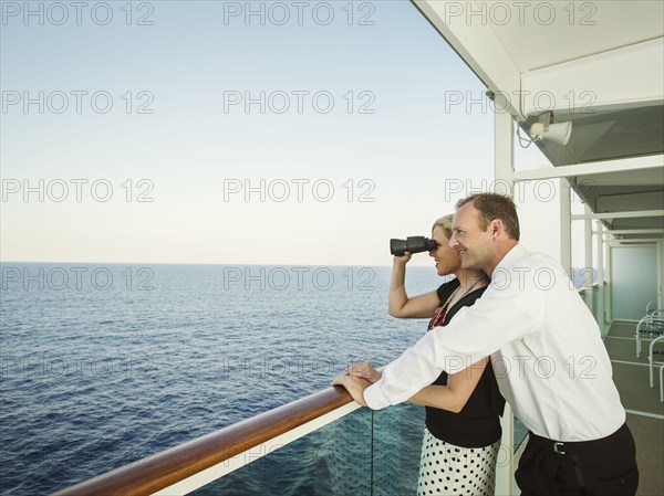 Caucasian couple admiring view from boat deck