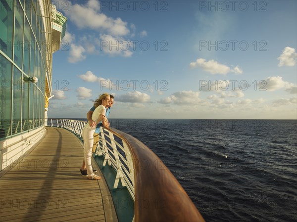 Caucasian couple admiring view from boat deck