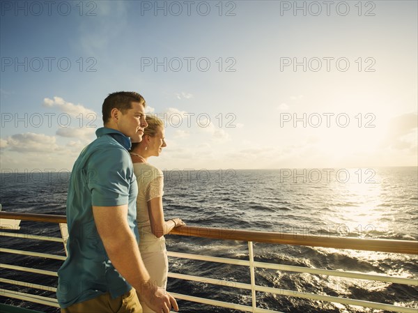 Caucasian couple admiring view from boat deck