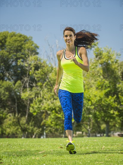 Mixed race woman jogging in park