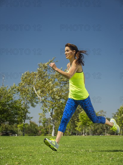 Mixed race woman jogging in park