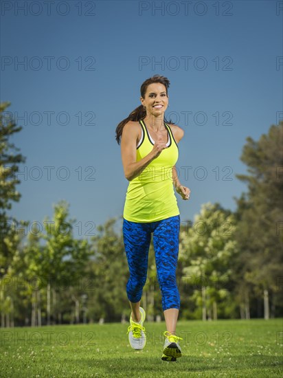 Mixed race woman jogging in park