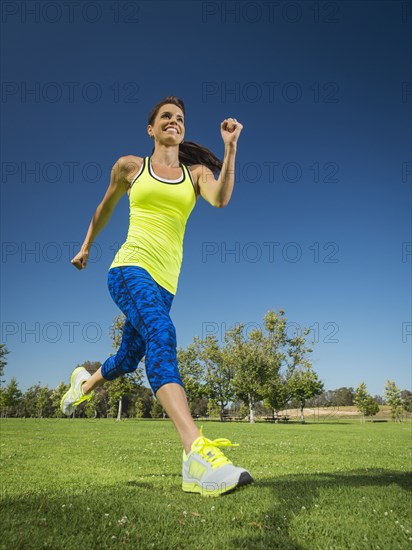 Mixed race woman jogging in park