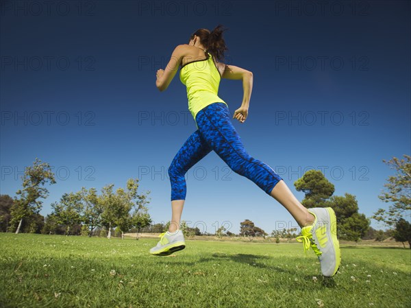 Mixed race woman jogging in park