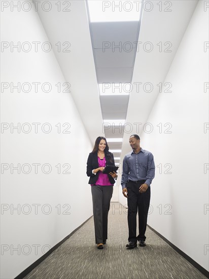 Business people talking in office corridor