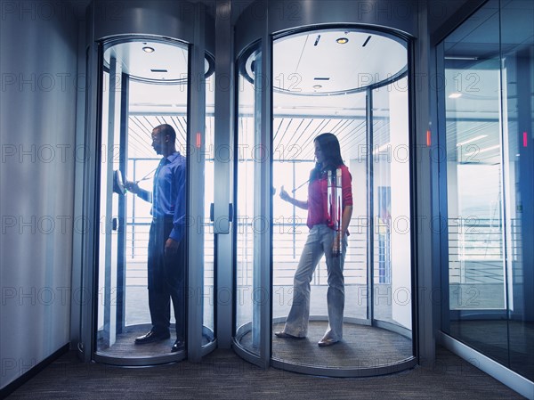 Business people using fingerprint lock system in office