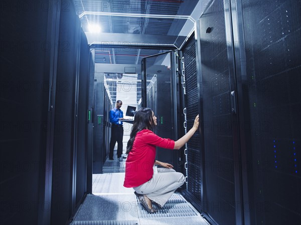 Business people working in server room