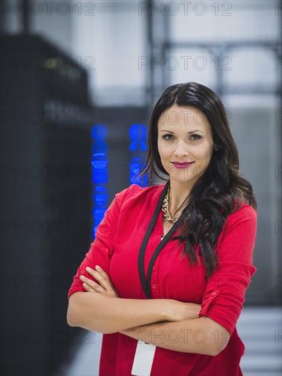 Caucasian businesswoman smiling in server room