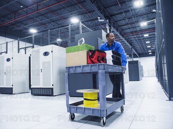 Black businessman working in server room