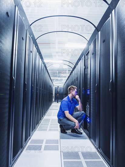 Caucasian businessman working in server room