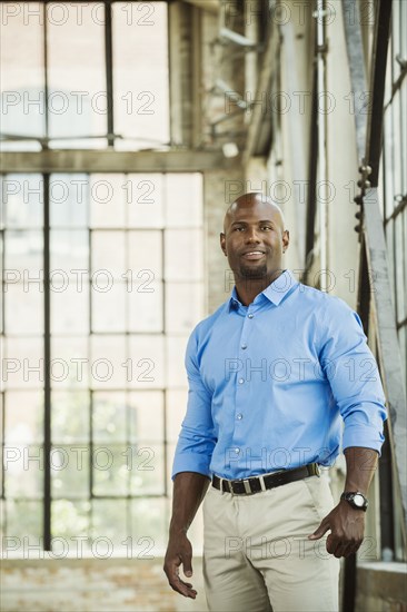 Black businessman smiling in warehouse