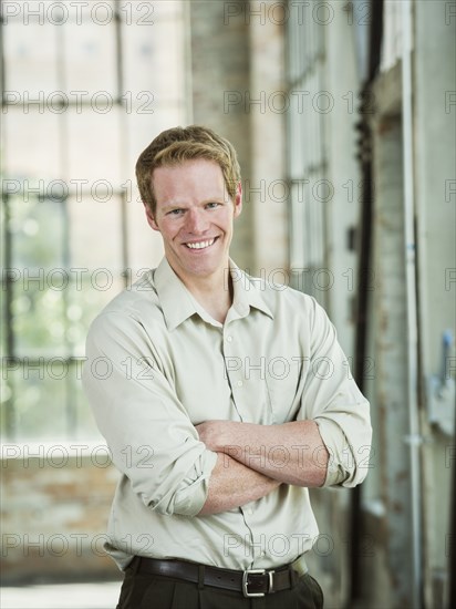 Caucasian businessman smiling in warehouse