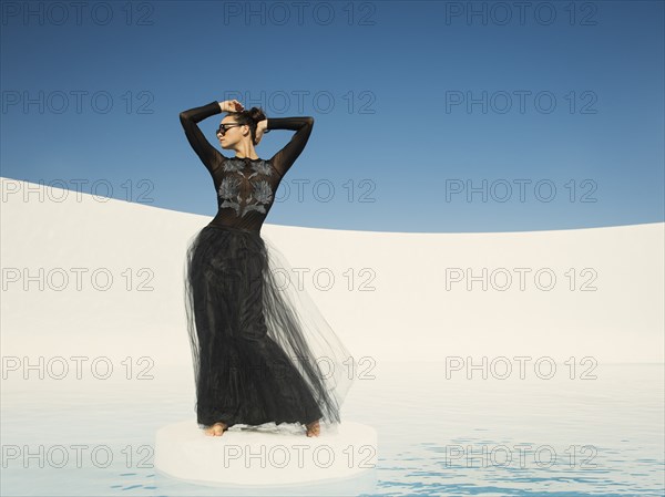 Caucasian woman in evening gown on ice floe