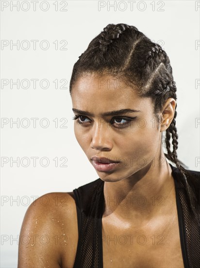 Close up of mixed race woman with braided hair