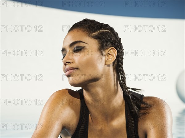 Mixed race woman with braided hair and eyes closed