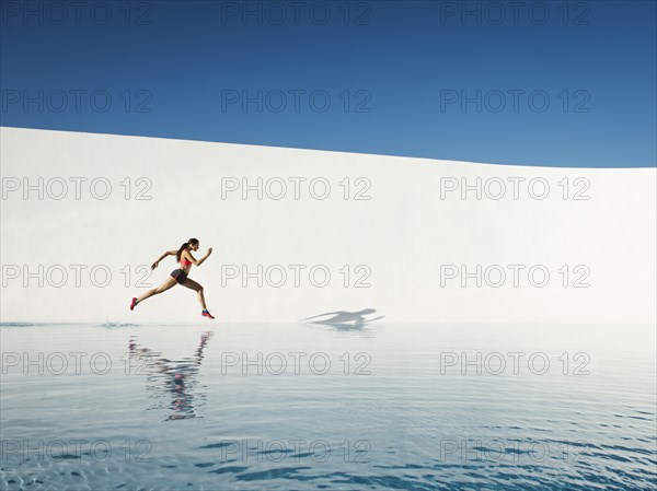 Caucasian woman running on water surface