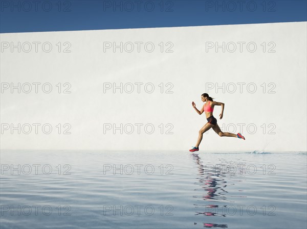 Caucasian woman running on water surface