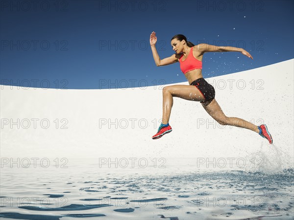 Caucasian woman running on water surface