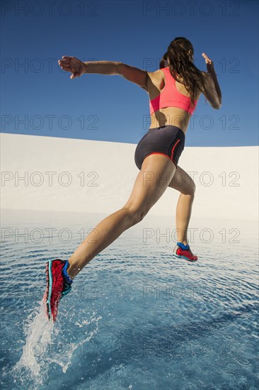 Caucasian woman running on water surface