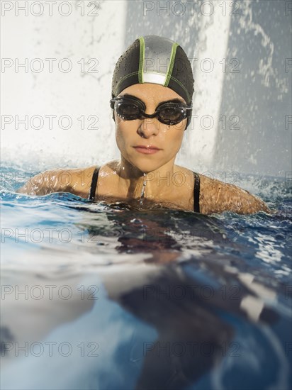 Caucasian swimmer with swimming cap in swimming pool