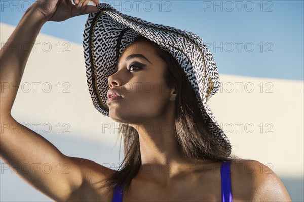 Mixed race woman wearing sun hat