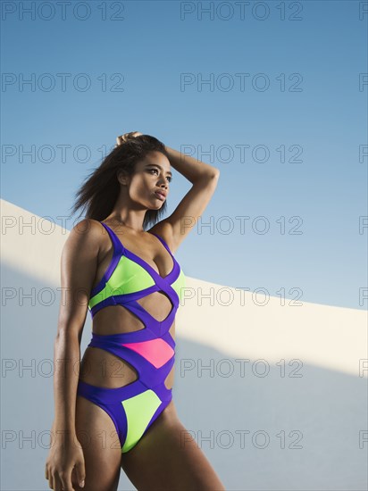 Mixed race woman wearing colorful swimsuit