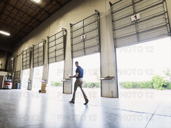 Blurred view of Caucasian worker walking in warehouse