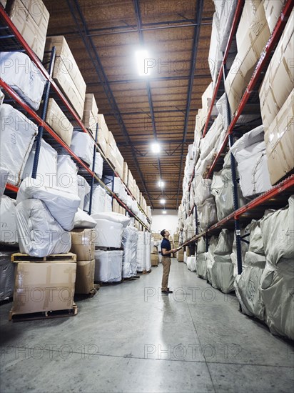 Caucasian worker checking inventory in warehouse