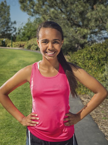 Mixed race girl smiling in park