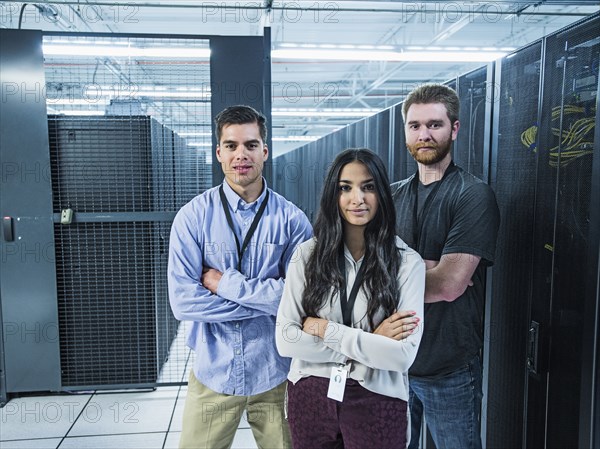 Technicians smiling in server room