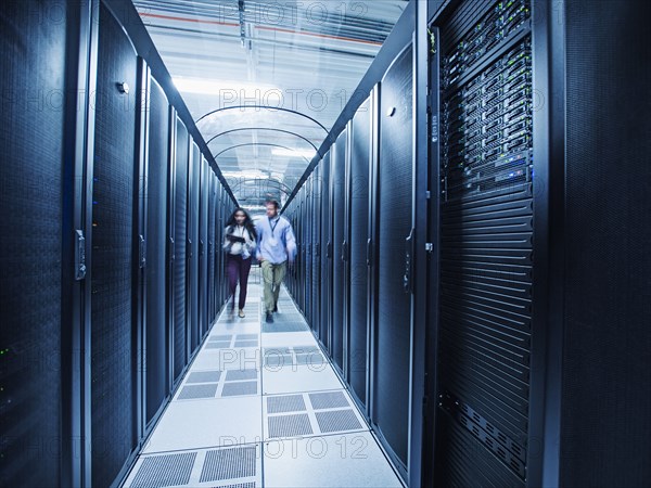 Technicians walking in server room